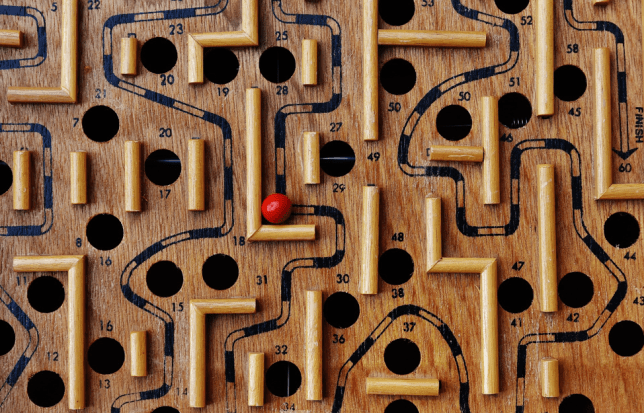 Photo of board game with ball moving around a maze