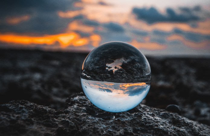 Photo of glass globe in sunset landscape