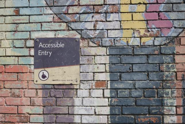 Photo of a painted wall with an accessible entry sign