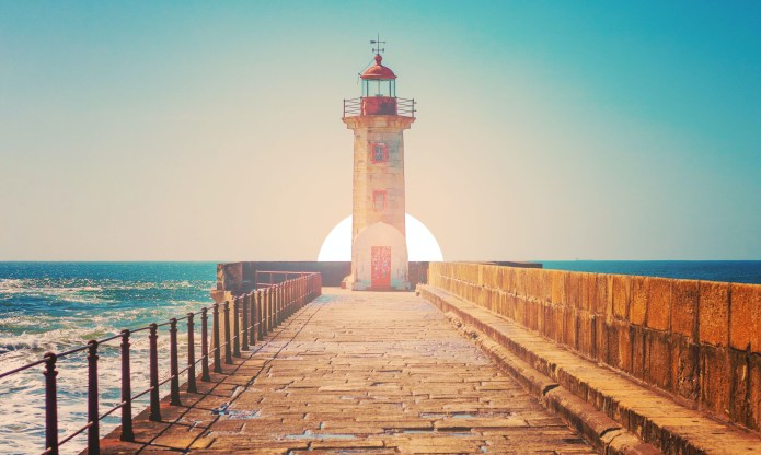 Photo of a lighthouse at the end of a pier
