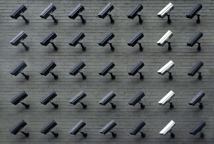 Photo of many security cameras mounted on a wall